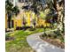 Exterior view of condo building featuring landscaped grounds with walking path at 3368 Robert Trent Jones Dr # 40808, Orlando, FL 32835