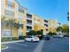 Condominium building featuring a bright exterior with ample parking on a clear day at 3368 Robert Trent Jones Dr # 40808, Orlando, FL 32835