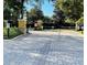 View of the gated entrance and manicured landscaping enhancing privacy and curb appeal at 3368 Robert Trent Jones Dr # 40808, Orlando, FL 32835
