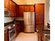 Modern kitchen with stainless steel appliances, granite counters, and wood cabinets at 3368 Robert Trent Jones Dr # 40808, Orlando, FL 32835