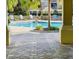 Outdoor pool area with plenty of seating surrounded by beautiful stone pavers and tropical landscaping at 3368 Robert Trent Jones Dr # 40808, Orlando, FL 32835