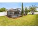 Well-maintained backyard featuring a screened-in pool, lush lawn, and a playground set at 350 Black Springs Ln, Winter Garden, FL 34787