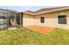 Backyard patio with grass and stone trim surrounding the building at 350 Black Springs Ln, Winter Garden, FL 34787