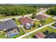 Landscaped backyard featuring a screened-in pool, playground, and privacy fence at 350 Black Springs Ln, Winter Garden, FL 34787