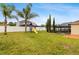 Large backyard with a swing set, playground, and a view of the screened-in pool area at 350 Black Springs Ln, Winter Garden, FL 34787