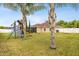 Spacious backyard featuring a playset, lush green grass, and partial view of the home's exterior at 350 Black Springs Ln, Winter Garden, FL 34787