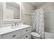 Bathroom with a white vanity, framed mirror, and a shower-tub combination with a patterned curtain at 350 Black Springs Ln, Winter Garden, FL 34787
