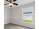 Bedroom showcasing a ceiling fan, light gray walls with trim, and modern flooring with natural light at 350 Black Springs Ln, Winter Garden, FL 34787