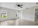 Bedroom featuring wood-look flooring, a ceiling fan, and large windows overlooking a green yard at 350 Black Springs Ln, Winter Garden, FL 34787