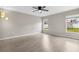 Empty room featuring wood-look flooring, and large windows overlooking a green yard at 350 Black Springs Ln, Winter Garden, FL 34787