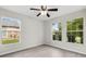 Sunlit bedroom featuring light gray walls, wood-look floors, and windows that provide ample natural light at 350 Black Springs Ln, Winter Garden, FL 34787
