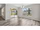 Bright dining area with gray wood-look flooring, sliding glass doors to a lanai, and abundant natural light at 350 Black Springs Ln, Winter Garden, FL 34787