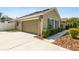 A charming home showcasing a two-car garage and well-maintained landscaping at 350 Black Springs Ln, Winter Garden, FL 34787