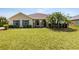 Charming single-story home with a well-manicured lawn and mature palm trees at 350 Black Springs Ln, Winter Garden, FL 34787