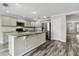 Modern kitchen featuring gray cabinets, stainless steel appliances and a large island at 350 Black Springs Ln, Winter Garden, FL 34787