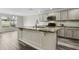 Kitchen featuring an island with marble countertops, gray cabinets, and stainless steel appliances at 350 Black Springs Ln, Winter Garden, FL 34787