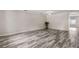 Large open living space features wood-look flooring, neutral walls, and ample natural light at 350 Black Springs Ln, Winter Garden, FL 34787