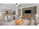 Open-concept living room featuring gray accents, wood-look floors and stainless steel appliances at 350 Black Springs Ln, Winter Garden, FL 34787