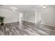 Open living room with stylish wood-look flooring, neutral walls, and a decorative rug at the entrance at 350 Black Springs Ln, Winter Garden, FL 34787