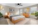 Light and airy main bedroom featuring a king-sized bed, wood flooring, and large windows at 350 Black Springs Ln, Winter Garden, FL 34787