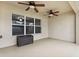 Large, covered patio with dual ceiling fans and a storage box, offering a relaxing outdoor space at 350 Black Springs Ln, Winter Garden, FL 34787