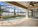 Covered patio with a ceiling fan overlooking a screened-in pool and manicured backyard at 350 Black Springs Ln, Winter Garden, FL 34787