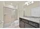 Well-lit bathroom featuring a walk-in shower and granite countertop at 3729 Pacific Ln, Davenport, FL 33897
