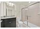 Bathroom with a granite-topped vanity and a shower with sliding glass doors at 3729 Pacific Ln, Davenport, FL 33897