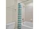 Bright bathroom features a clean white toilet and a tub with decorative shower curtain at 3729 Pacific Ln, Davenport, FL 33897