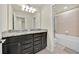 Bathroom with a double sink vanity and granite countertops, plus a shower-tub combo at 3729 Pacific Ln, Davenport, FL 33897