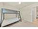 Neutral bedroom featuring a sturdy black metal bunk bed with plush mattresses for restful sleep at 3729 Pacific Ln, Davenport, FL 33897