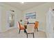 Dining area with seating for four and access to the screened-in patio through a glass door at 3729 Pacific Ln, Davenport, FL 33897
