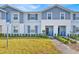 Inviting exterior of a charming townhome with a well-manicured lawn and a welcoming entrance at 3729 Pacific Ln, Davenport, FL 33897