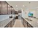 Modern kitchen featuring granite countertops, stainless steel appliances, and ample cabinetry at 3729 Pacific Ln, Davenport, FL 33897