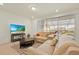 Cozy living room with a large TV, comfortable seating, and access to the screened-in porch at 3729 Pacific Ln, Davenport, FL 33897