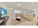 Bright living room featuring two sofas, a decorative rug, and sliding doors to the patio at 3729 Pacific Ln, Davenport, FL 33897