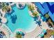 Aerial shot of the large community pool with blue umbrellas at 3838 Lana Ave, Davenport, FL 33897
