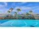 Outdoor basketball court with blue surface, hoop, and community buildings in the background at 3838 Lana Ave, Davenport, FL 33897