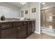 Bathroom featuring a double vanity with granite countertops and a glass-enclosed shower at 3838 Lana Ave, Davenport, FL 33897