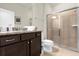 Well-lit bathroom with granite countertop and glass shower at 3838 Lana Ave, Davenport, FL 33897