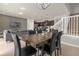 An open-concept dining area features a modern table and chairs, seamlessly connecting living spaces at 3838 Lana Ave, Davenport, FL 33897