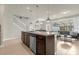 Bright open-concept kitchen with island, stainless appliances, and adjacent living area at 3838 Lana Ave, Davenport, FL 33897