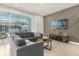 Comfortable living room with sectional sofa and sliding glass doors that lead to an outdoor pool area at 3838 Lana Ave, Davenport, FL 33897