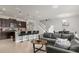 Open-concept living space with kitchen island, modern appliances, and comfortable seating area at 3838 Lana Ave, Davenport, FL 33897