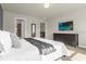 Bright main bedroom with a large bed, TV, and access to ensuite bathroom at 3838 Lana Ave, Davenport, FL 33897