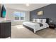 Spacious main bedroom featuring large windows and a stylish accent wall at 3838 Lana Ave, Davenport, FL 33897