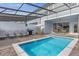 Inviting screened-in pool with patio furniture, grill, and a covered dining area for outdoor relaxation at 3838 Lana Ave, Davenport, FL 33897