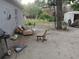View of the home's backyard with chairs and a grill at 405 N Oakland St, Leesburg, FL 34748