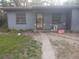 View of a single-story home featuring a concrete walk and lawn at 405 N Oakland St, Leesburg, FL 34748