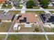 Aerial view of a fenced backyard, showcasing solar panels on the roof, patio area, and storage shed at 408 Magpie Ct, Kissimmee, FL 34759